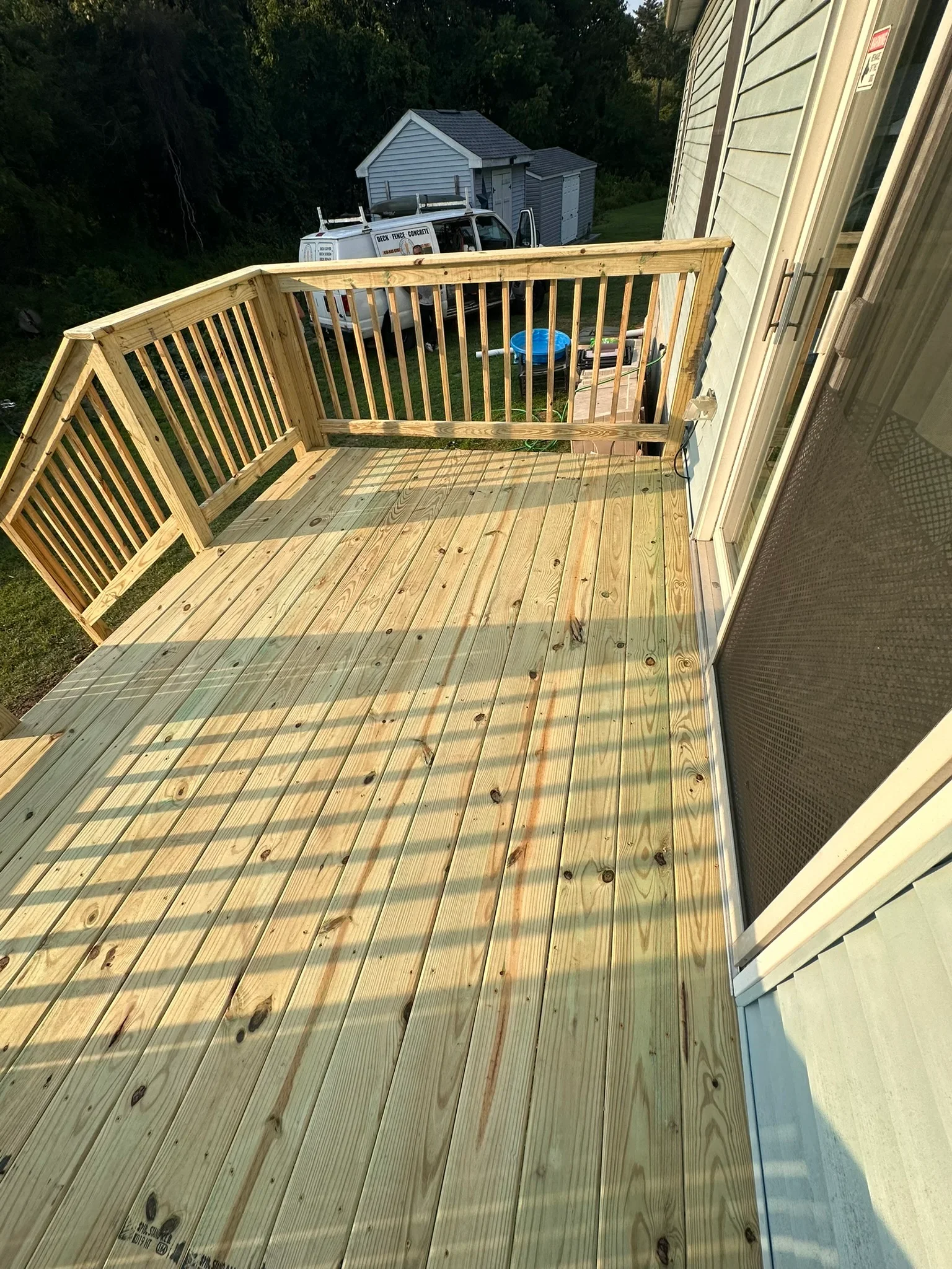 New wooden deck with composite railings attached to residential home in Baltimore