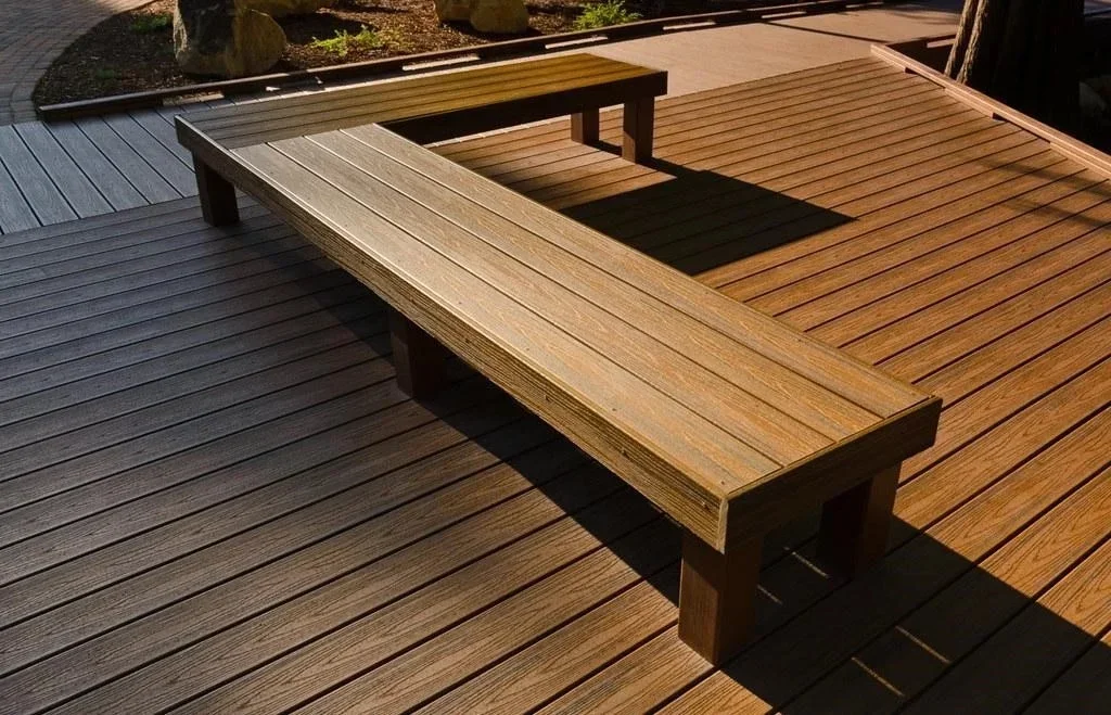 Large composite deck with two built-in wooden benches and metal railings